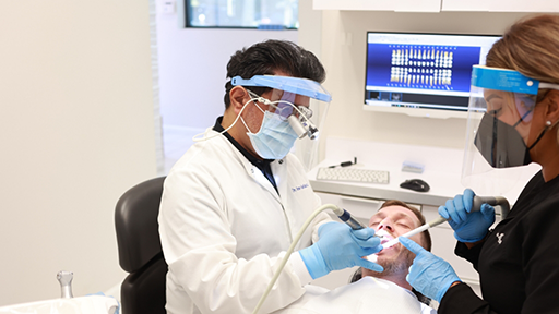 Dentist and assistant performing a procedure on a patient
