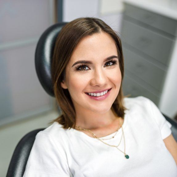 Woman in dental chair smiling