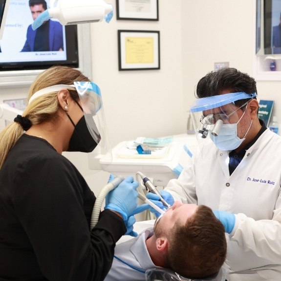 Dentist and dental team member providing dentistry services