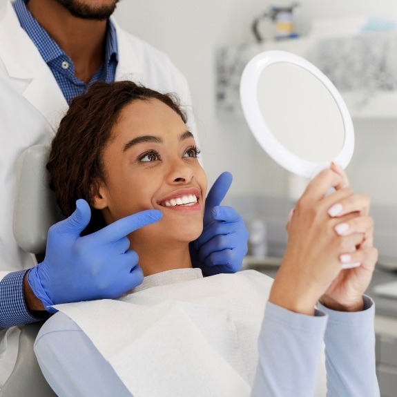 Woman looking at smile after virtual smile design