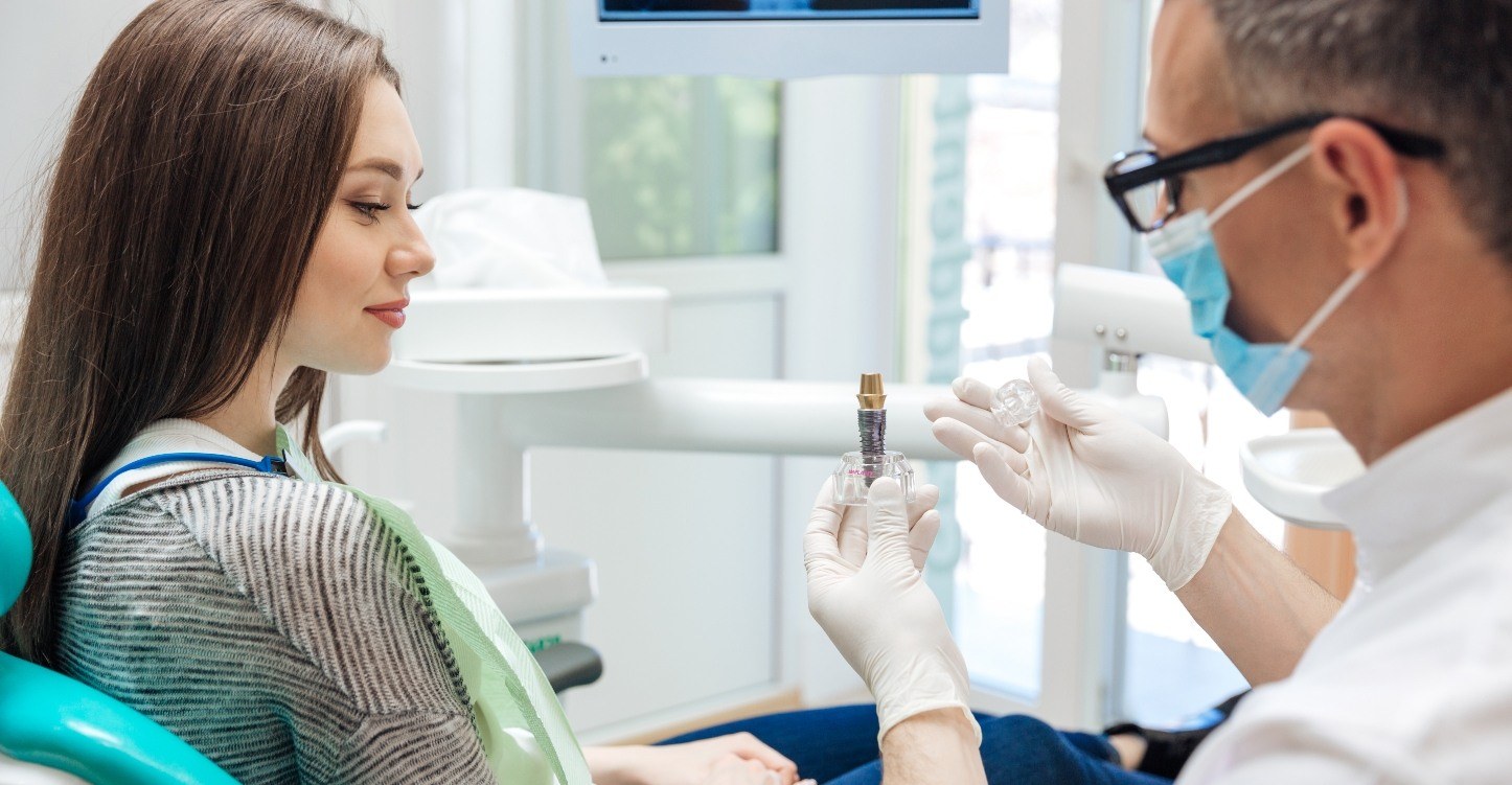 Dentist explaining what dental implants are