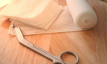 Roll of gauze and a pair of scissors