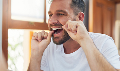 Man flossing his teeth