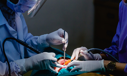 Dentist and assistant performing a procedure on a patient