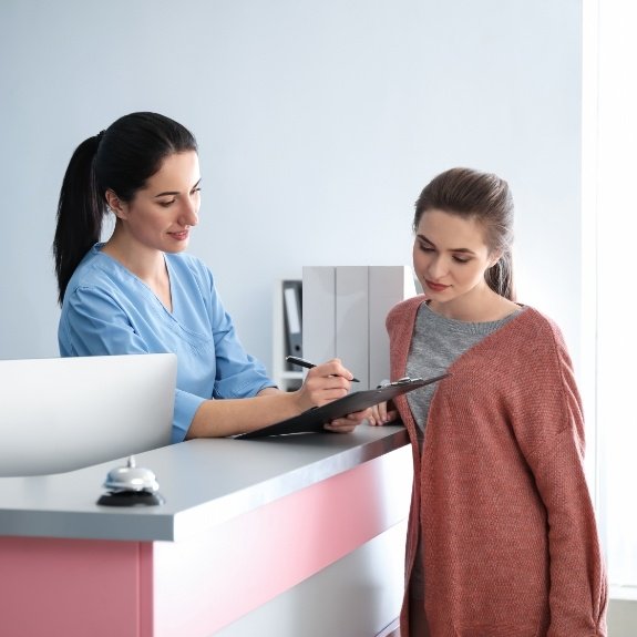 Woman at dental office to prevent emergency dentistry