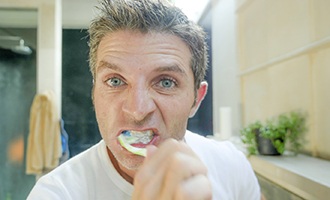 Man brushes teeth