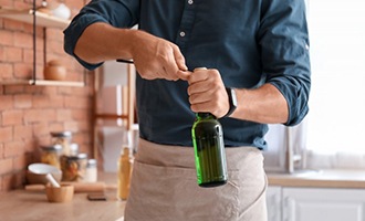 Man opens bottle with bottle opener