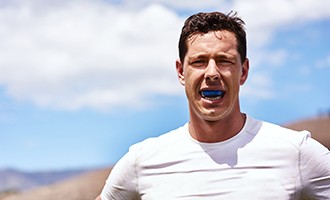 Man wears athletic mouthguard