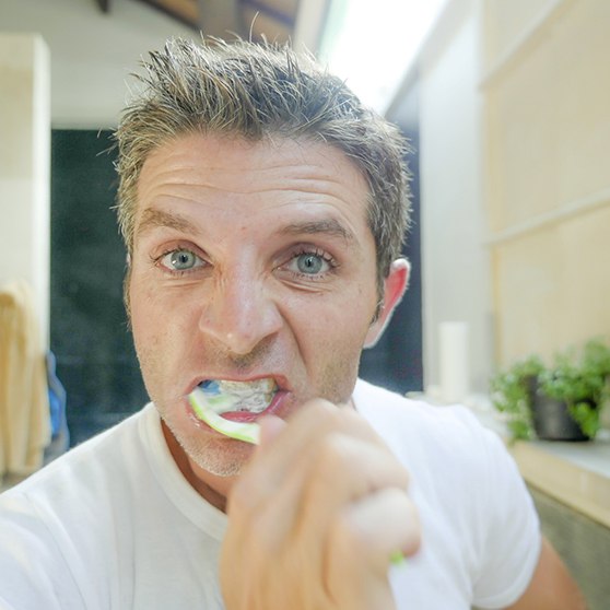 Man brushes teeth