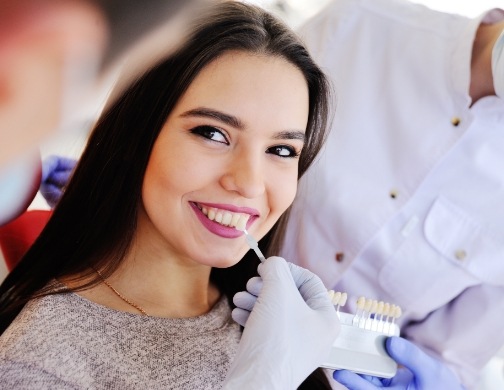 Woman smiling during cosmetic veneers consultation