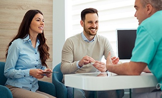 Couple discusses matters with their dentist