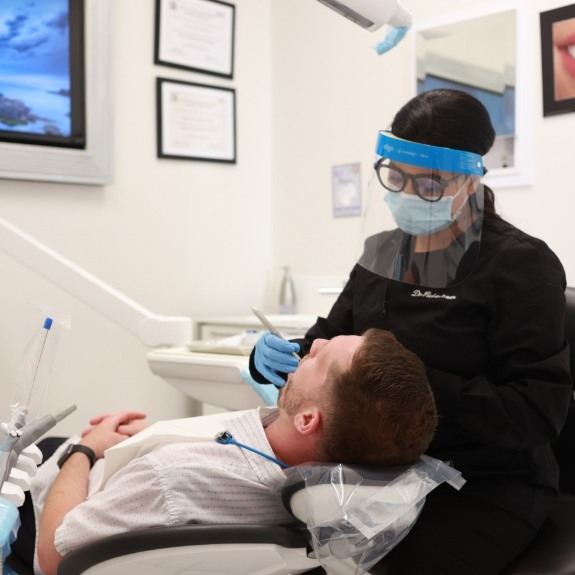 Dental team member treating dentistry patient