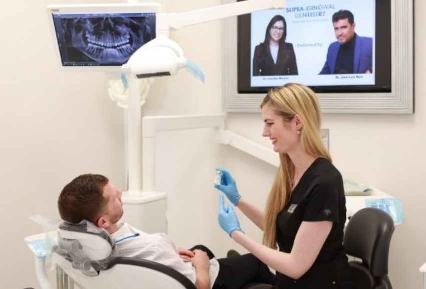 Dental team member showing a vial of medicine to a patient