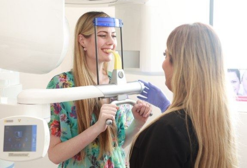 Dental patient getting a CT cone beam scan of her mouth and jaws