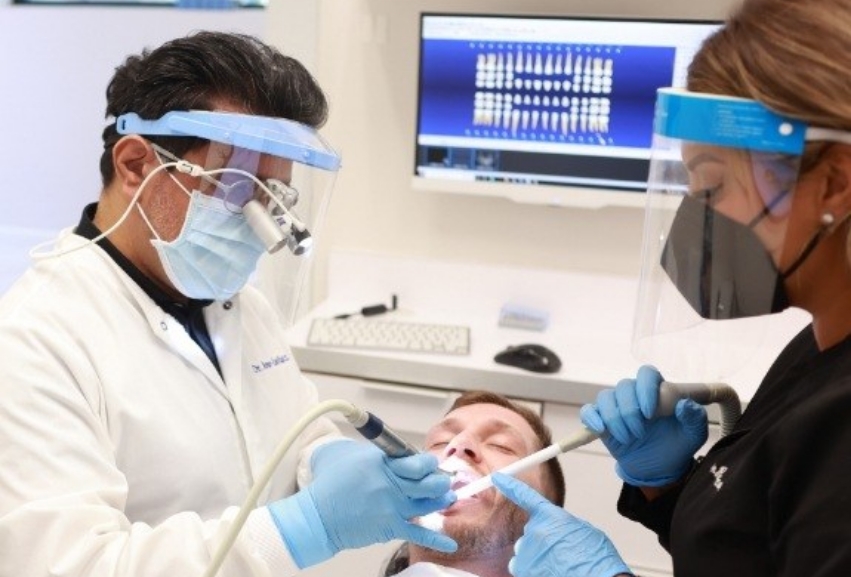 Doctor Ruiz and an assistant treating a patient