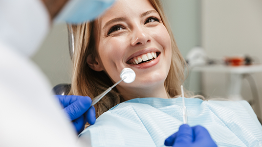 Woman smiling at her dentist during a checkup