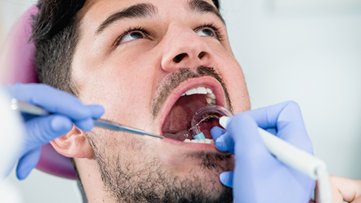 Man having his mouth examined by his dentist