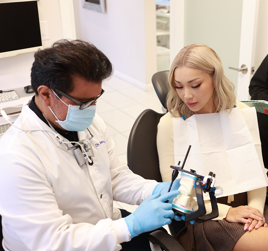Doctor Ruiz talking to a patient about dental services in Burbank