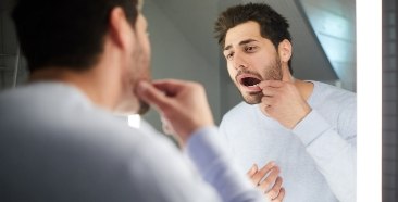 Man looking at damaged smile before cosmetic dentistry