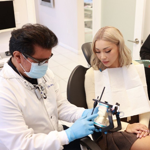 Dentist using smile model to explain supra gingival dentistry