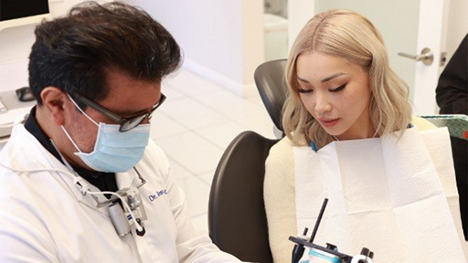 Doctor Ruiz showing a dental instrument to a patient