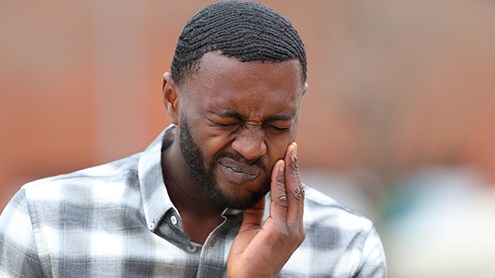 Man in collared shirt with jaw pain