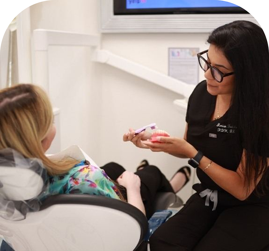 Burbank dental team member showing a denture to a patient