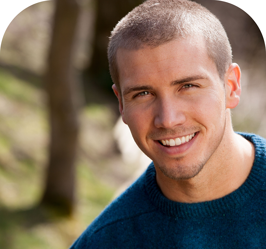Man in a blue sweater smiling with veneers in Burbank