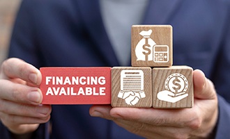 a person holding blocks with financial-related icons on them
