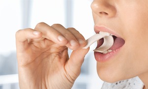 Woman about to bite down on stick of gum