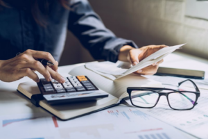 Woman using a calculator at her desk
